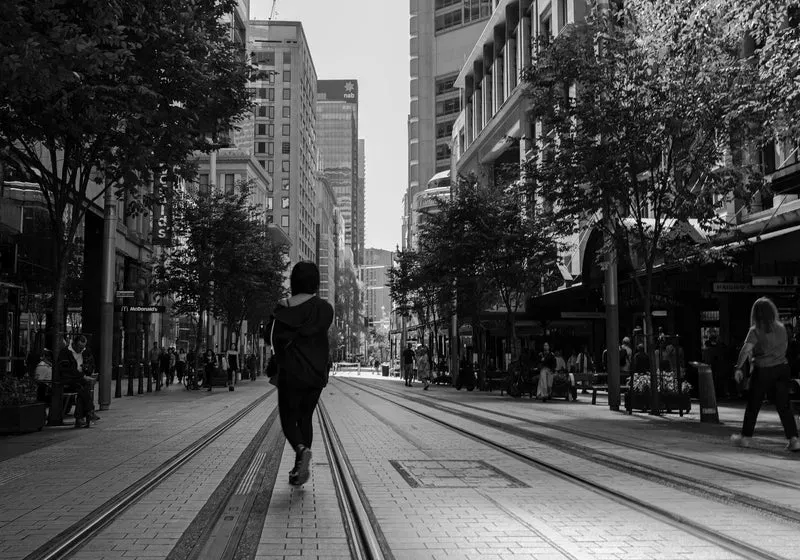 Candid street scene with a pedestrian walking through an urban district